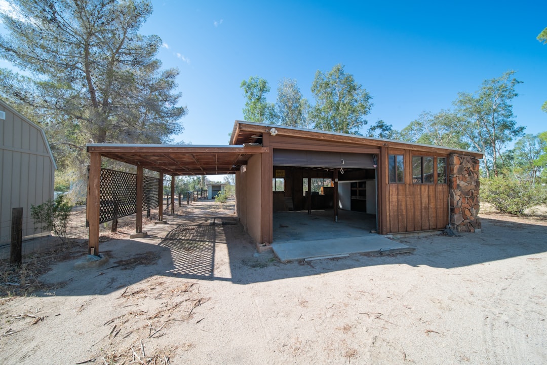 Detached outbuilding with a covered entrance on a cleared plot