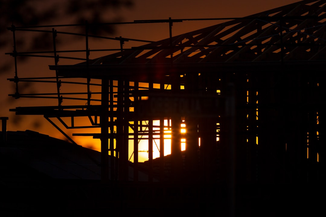 Timber-framed new build under construction with trades working on site